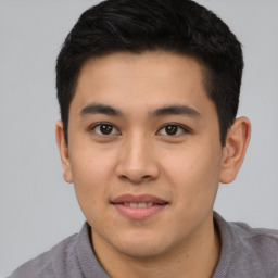 Joyful asian young-adult male with short  black hair and brown eyes