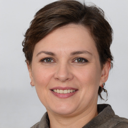 Joyful white adult female with medium  brown hair and grey eyes