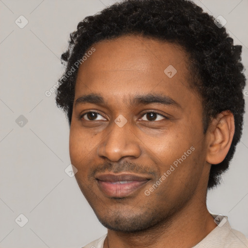 Joyful black young-adult male with short  black hair and brown eyes