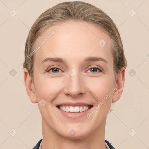 Joyful white young-adult female with short  brown hair and grey eyes