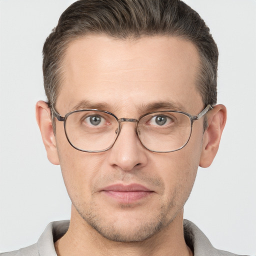 Joyful white adult male with short  brown hair and brown eyes