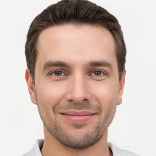 Joyful white young-adult male with short  brown hair and brown eyes