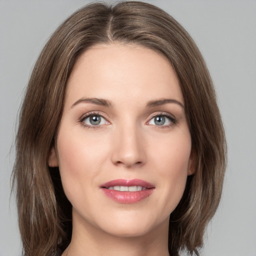 Joyful white young-adult female with medium  brown hair and green eyes