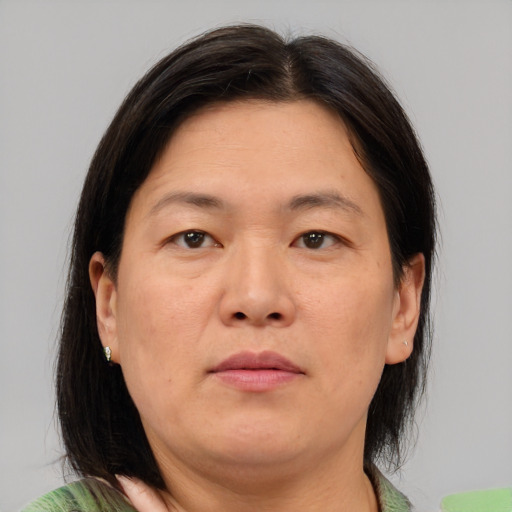 Neutral asian adult female with medium  brown hair and brown eyes