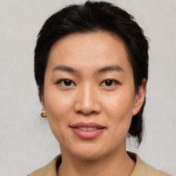 Joyful asian young-adult female with short  brown hair and brown eyes