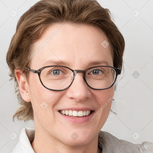 Joyful white adult female with medium  brown hair and blue eyes