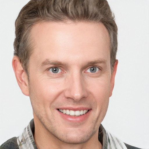 Joyful white adult male with short  brown hair and grey eyes