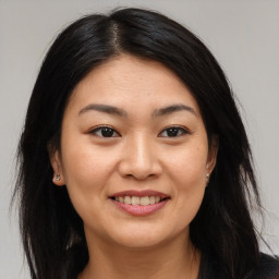 Joyful asian young-adult female with medium  brown hair and brown eyes