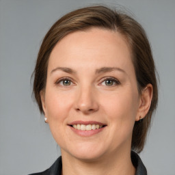 Joyful white young-adult female with medium  brown hair and grey eyes