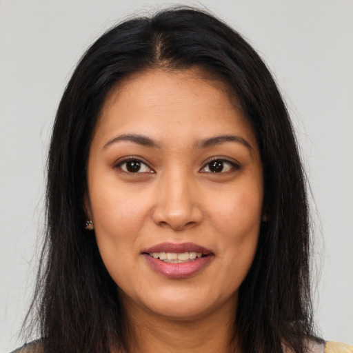 Joyful latino young-adult female with long  brown hair and brown eyes