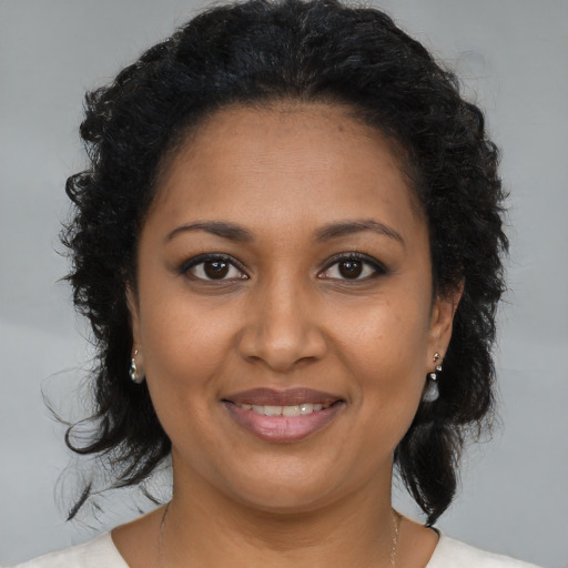 Joyful black young-adult female with medium  brown hair and brown eyes