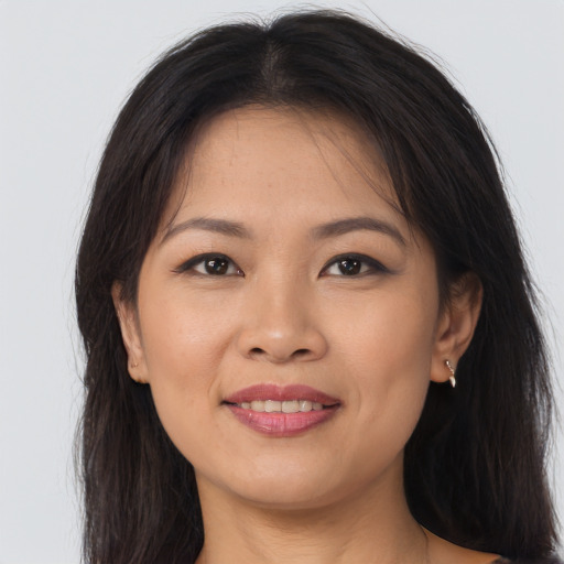 Joyful asian young-adult female with long  brown hair and brown eyes