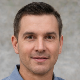 Joyful white adult male with short  brown hair and brown eyes