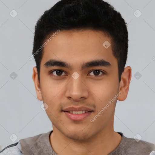 Joyful latino young-adult male with short  brown hair and brown eyes