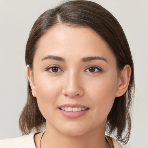 Joyful white young-adult female with medium  brown hair and brown eyes