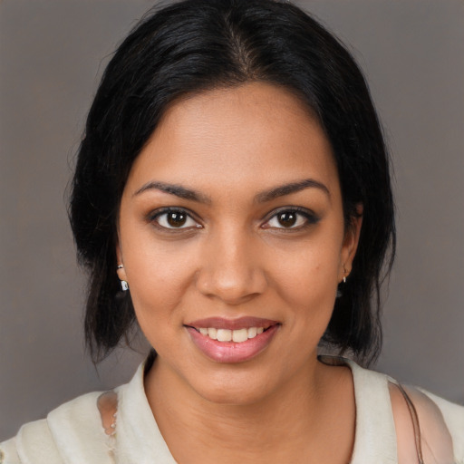 Joyful black young-adult female with medium  black hair and brown eyes