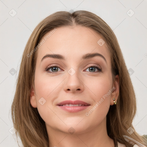 Joyful white young-adult female with long  brown hair and green eyes