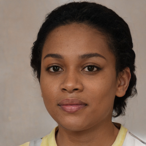 Joyful black young-adult female with short  brown hair and brown eyes