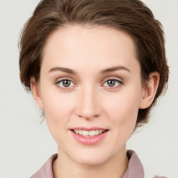 Joyful white young-adult female with medium  brown hair and green eyes