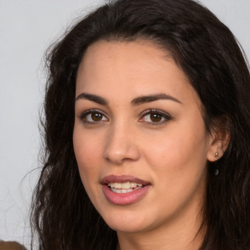 Joyful white young-adult female with long  brown hair and brown eyes