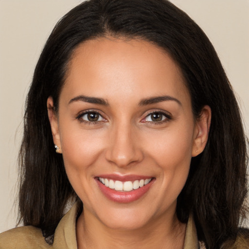 Joyful white young-adult female with long  brown hair and brown eyes