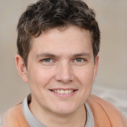 Joyful white adult male with short  brown hair and brown eyes