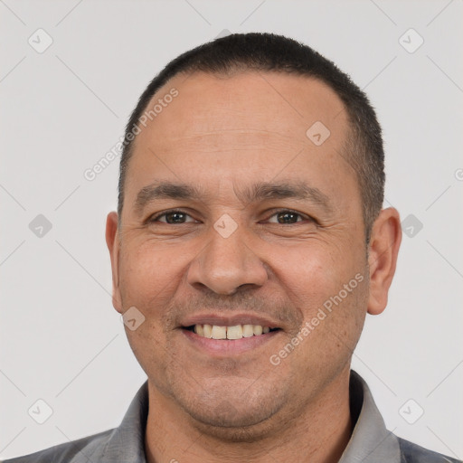 Joyful white adult male with short  black hair and brown eyes