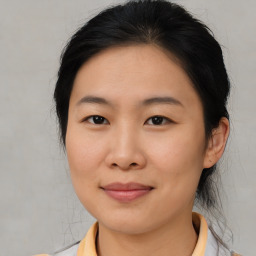 Joyful asian young-adult female with medium  brown hair and brown eyes