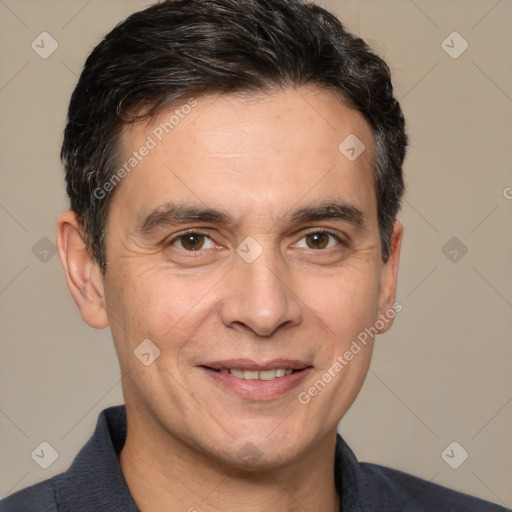 Joyful white adult male with short  black hair and brown eyes