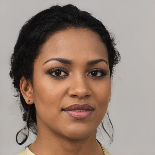 Joyful black young-adult female with medium  brown hair and brown eyes