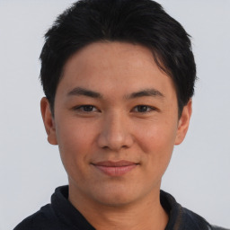 Joyful asian young-adult male with short  black hair and brown eyes