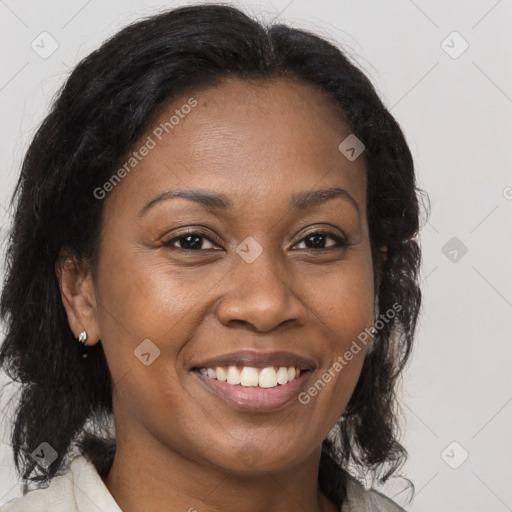 Joyful black adult female with medium  brown hair and brown eyes