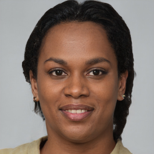 Joyful black young-adult female with short  brown hair and brown eyes