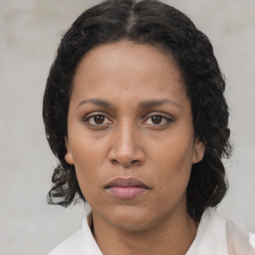 Neutral black young-adult female with medium  brown hair and brown eyes