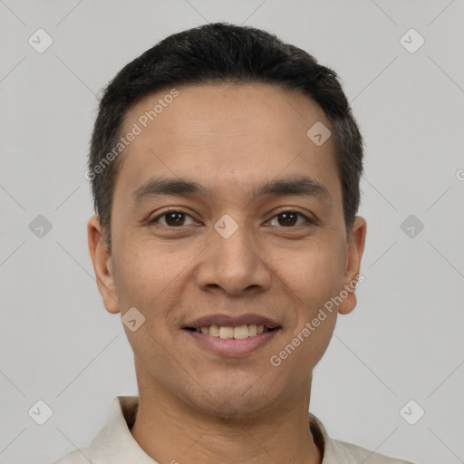 Joyful latino young-adult male with short  black hair and brown eyes