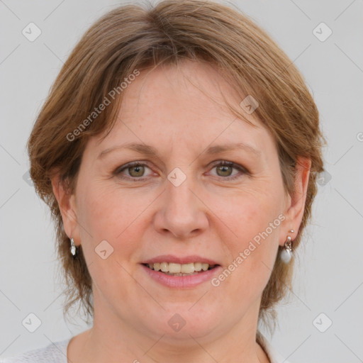 Joyful white adult female with medium  brown hair and blue eyes