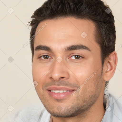 Joyful white young-adult male with short  brown hair and brown eyes