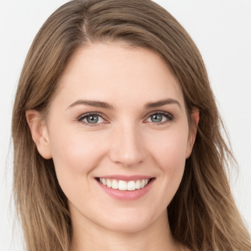 Joyful white young-adult female with long  brown hair and grey eyes