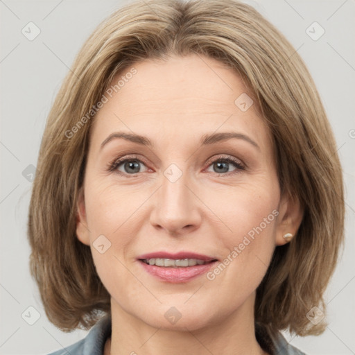 Joyful white adult female with medium  brown hair and grey eyes