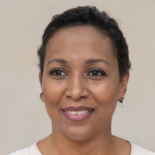 Joyful latino adult female with short  black hair and brown eyes