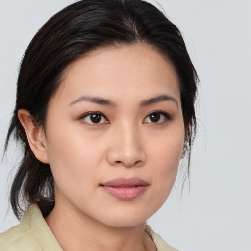 Joyful asian young-adult female with medium  brown hair and brown eyes
