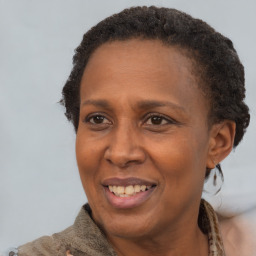 Joyful black adult female with short  brown hair and brown eyes