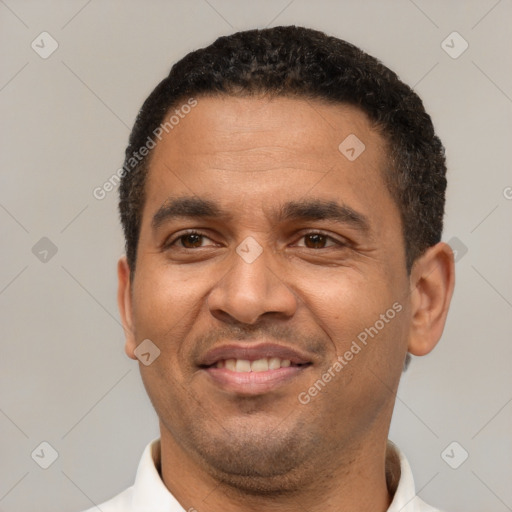 Joyful latino adult male with short  black hair and brown eyes