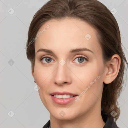 Joyful white young-adult female with medium  brown hair and grey eyes