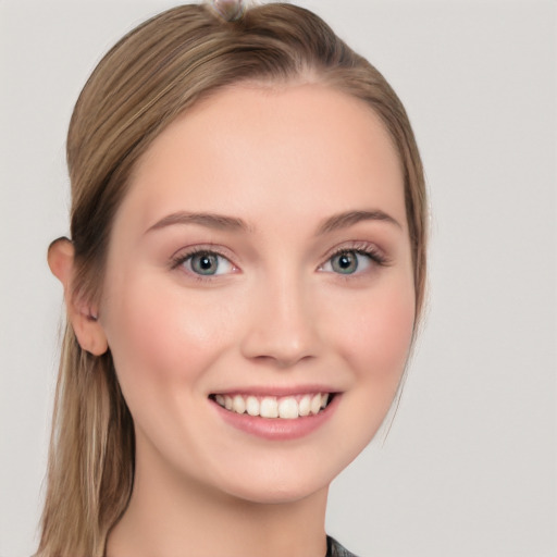 Joyful white young-adult female with long  brown hair and blue eyes