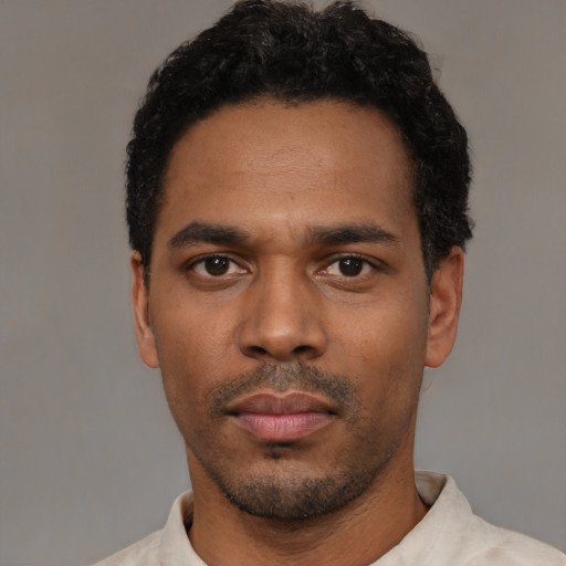 Neutral black young-adult male with short  black hair and brown eyes