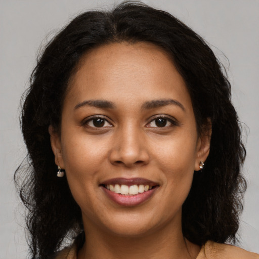 Joyful latino young-adult female with long  brown hair and brown eyes