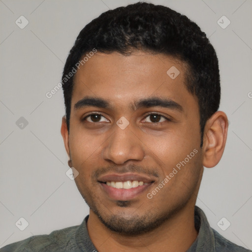 Joyful black young-adult male with short  black hair and brown eyes