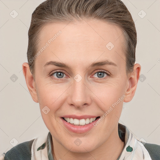 Joyful white young-adult female with short  brown hair and grey eyes