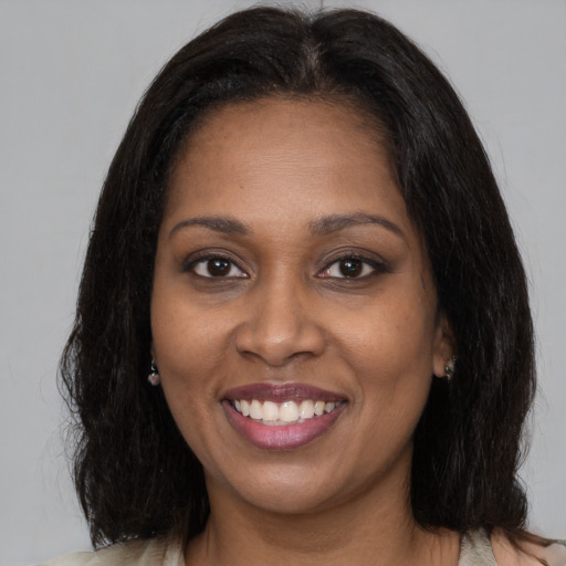 Joyful black young-adult female with medium  brown hair and brown eyes